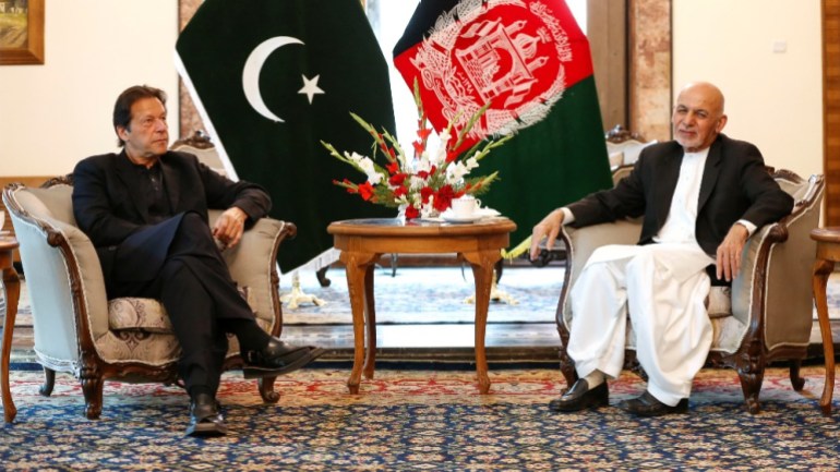 Afghan President Ashraf Ghani (R) meets with Pakistan's Prime Minister Imran Khan