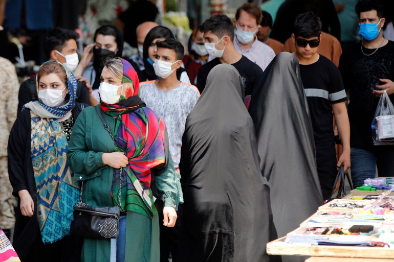 Iranian women wearing face masks walk around the Tajrish Bazaar in Tehran , Iran, 20 July 2021
