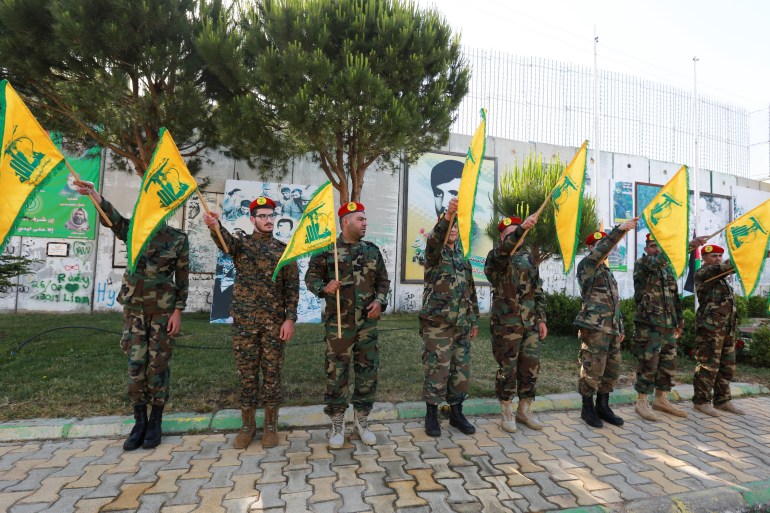 Hezbollah members holding flags