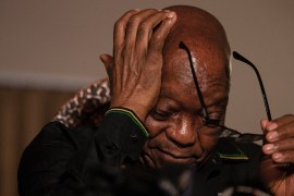 Former South African President Jacob Zuma removes his eyeglasses as he addresses the media in his home in Nkandla, KwaZulu-Natal on July 4, 2021 [File: Emmanuel Croset/AFP]