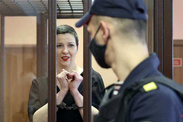 Maria Kolesnikova, the last remaining protest leader still in Belarus, gestures making a heart shape inside the defendants' cage during her verdict hearing on charges of undermining national security, conspiring to seize power and creating an extremist group, on September 6, 2021 in Minsk.
