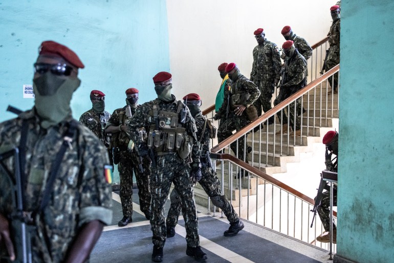 Colonel Mamady Doumbouya(4R) and his Special Forces leave the Peoples Palace after the first session of talks between the Colonel and current Guinean political parties in Conakry
