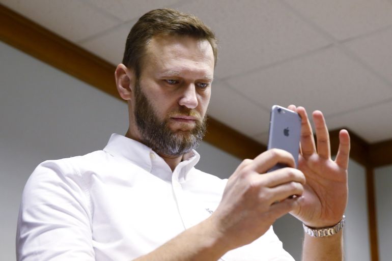 Russian anti-corruption campaigner and opposition figure Alexei Navalny takes a photo with his mobile phone during a hearing at the Moscow City Court in Moscow, Russia, February 12, 2016. Moscow court hears an appeal by Navalny on the amount of damage, that he needs to pay to the state timber firm Kirovles, local media reported. REUTERS/Maxim Shemetov