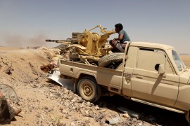 FILE PHOTO: A Yemeni government fighter fires a vehicle-mounted weapon at a frontline position during fighting against Houthi fighters in Marib, Yemen March 28, 2021.