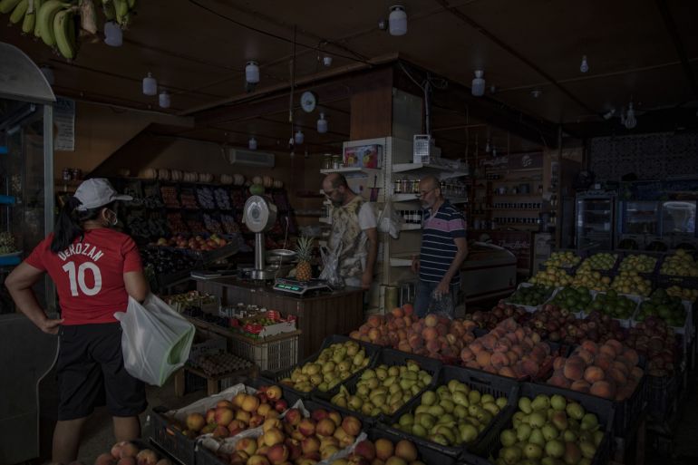 A customer shops in a grocery store during a power cut in Beirut, Lebanon