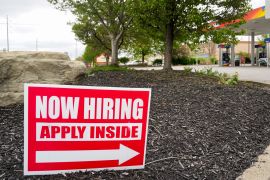Hiring signs are posted outside a gas station in Cranberry Township, Butler County, Pa.