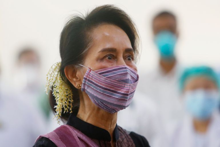 In this Jan. 27, 2021, file photo, Myanmar leader Aung San Suu Kyi watches the vaccination of health workers at a hospital in Naypyitaw, Myanmar.