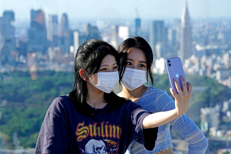 Visitors take a selfie on the observation deck of the Shibuya Sky