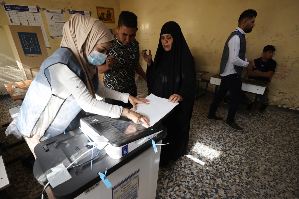 An Iraqi woman registers at a polling station in Baghdad, Iraq
