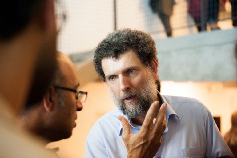 Osman Kavala speaking during an event.