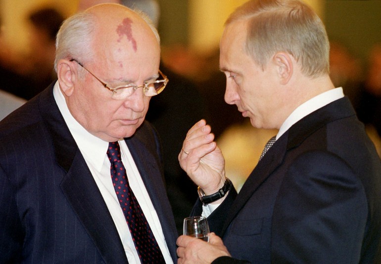 Gorbachev and Vladimir Putin having a conversation.