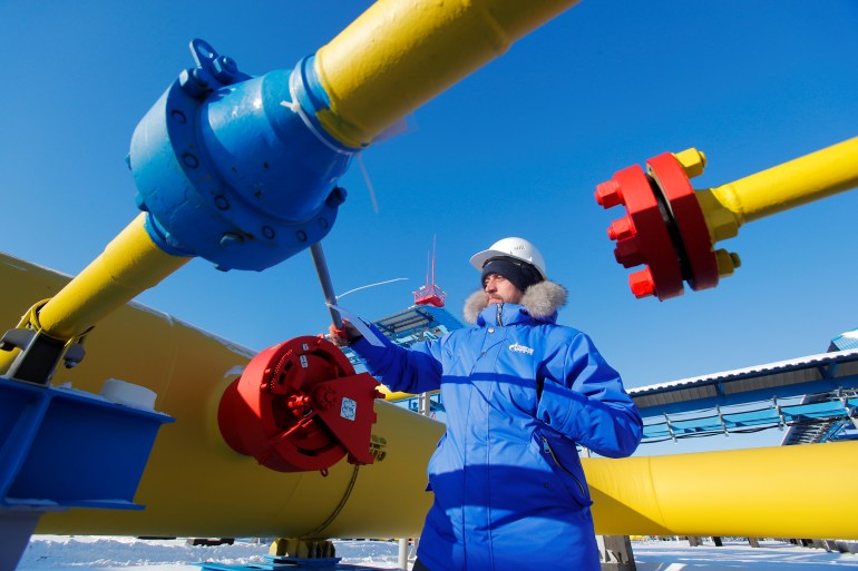 An employee checks a gas valve at the Atamanskaya compressor station