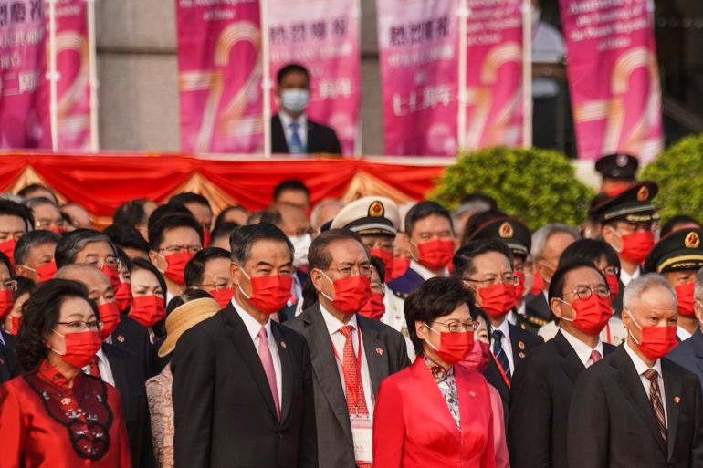Hong Kong Chief Executive Carrie Lam and former Chief Executive Leung Chun-ying stand beside their spouses, Lam Siu-por and Regina Tong, during a flag-raising ceremony marking the Chinese National Day in Hong Kong, China October 1, 2021.