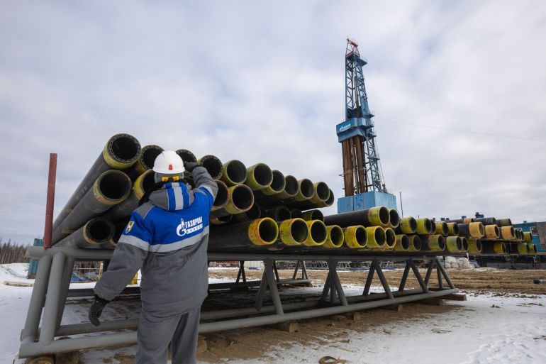 A worker inspects drilling pipes at a gas drilling.