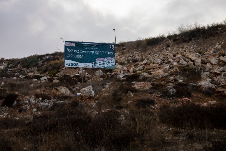 A billboard advertising housing projects hangs on a hill in the West Bank Jewish settlement of Ariel near the Palestinian town of Nablus