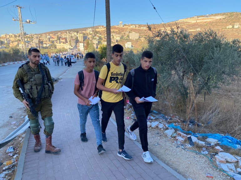 Palestinian schoolkids are forced to walk along a highway used by settlers to get to their school in Luban Ash-Sharqiya, in Nablus, northern occupied West