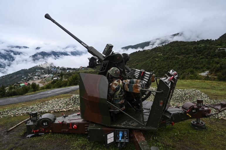An Indian Army soldier sits inside an upgraded L70 anti aircraft gun in Tawang
