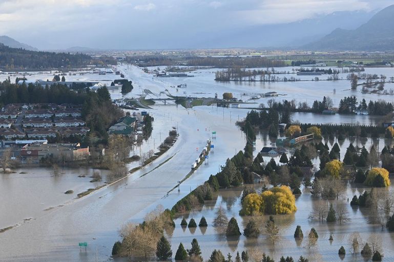 This aerial handout image taken and released on November 16, 2021 by the City of Abbotsford via Twitter shows flooding on the Sumas Prairie in Abbotsford, Canada. - At least one person has died in torrential rains that forced thousands in western Canada to evacuate their homes and trapped motorists in mudslides, federal police said on November 16, 2021. (Photo by Handout / CITY OF ABBOTSFORD / AFP) / RESTRICTED TO EDITORIAL USE - MANDATORY CREDIT "AFP PHOTO / CITY OF ABBOTSFORD " - NO MARKETING - NO ADVERTISING CAMPAIGNS - DISTRIBUTED AS A SERVICE TO CLIENTS
