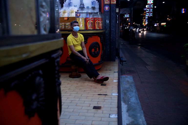 Man sitting street in Bangkok