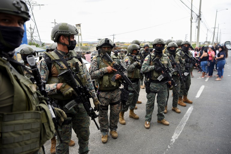 Security forces line up outside Guayaquil prison after a deadly riot inside