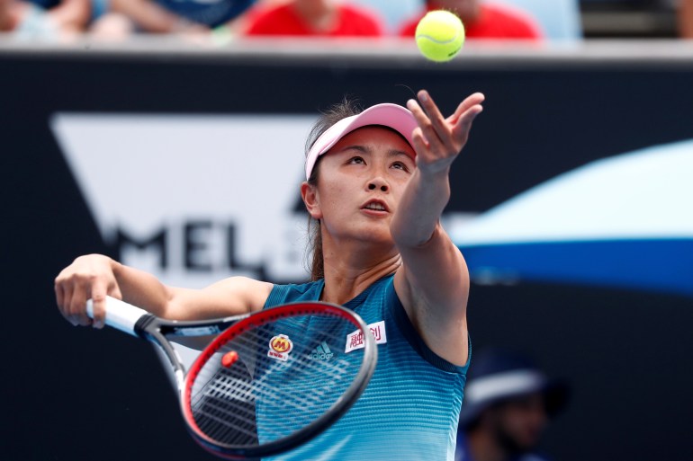 Former tennis star Peng Shuai serving in a game