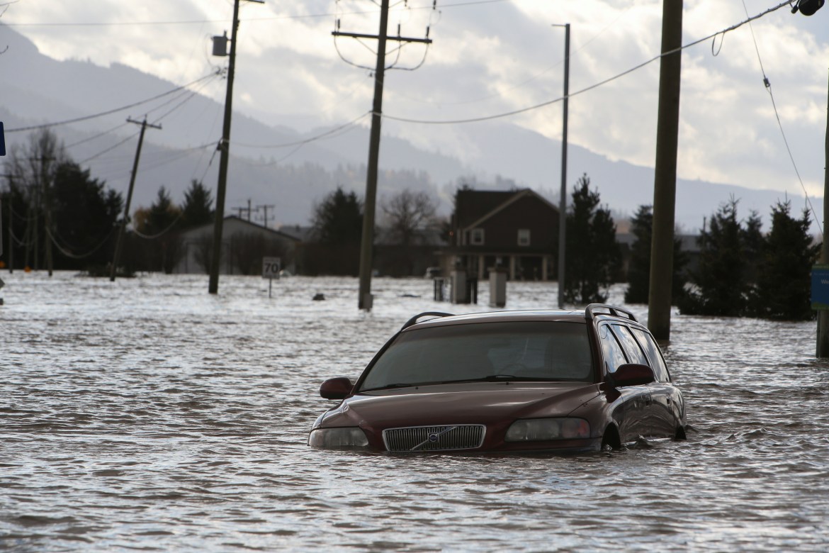A car is submerged in flood waters on a farm after rainstorms caused flooding and landslides in Abbotsford, British Columbia, Canada November 16, 2021. REUTERS/Jesse Winter