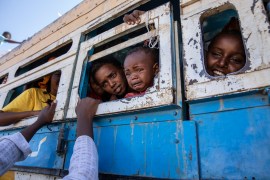 Tigray refugees who fled the conflict in their home region ride a bus going to a temporary shelter, near the Sudan-Ethiopia border, in Hamdayet, eastern Sudan