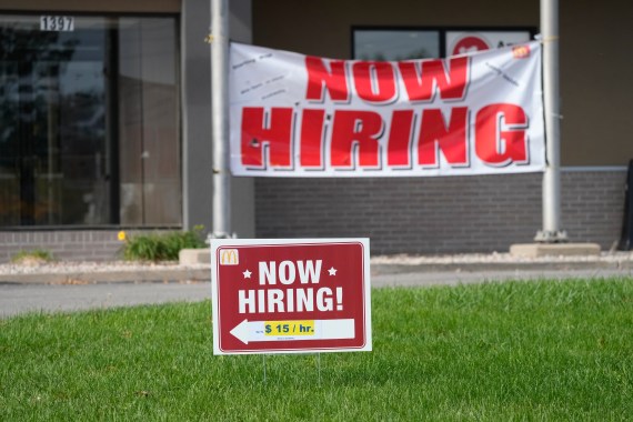 Now hiring signs stand in front of a McDonald's Sunday, Oct. 9, 2021, in Seward, Neb
