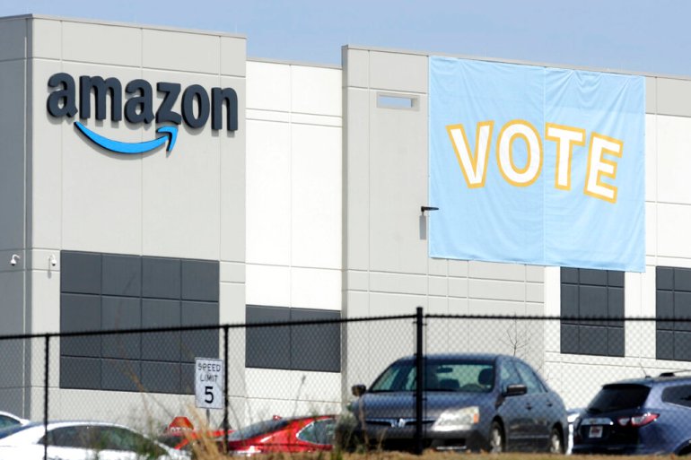 a banner encouraging workers to vote in labor balloting is shown at an Amazon warehouse in Bessemer, Ala., US