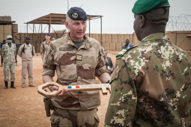 French colonel Faivre hands over the symbolic key of Camp Barkhane to the Malian colonel during the handover ceremony of the Barkhane military base to the Malian army in Timbuktu