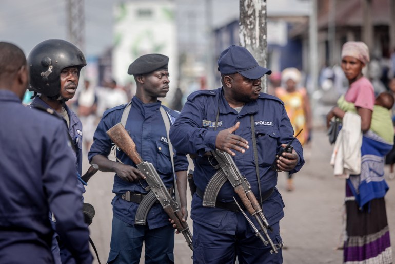 Police officers discuss a strategy to disperse demonstrators during a demonstration in Goma, eastern Democratic Republic of Congo