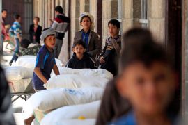People receiving aid at a warehouse