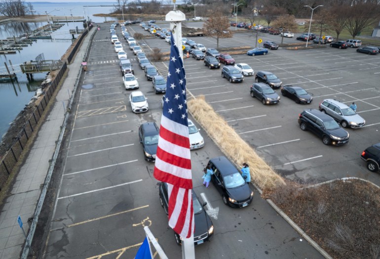 Long lines of cars at drive-through COVID-19 testing site at parking lot in Stamford, Connecticut