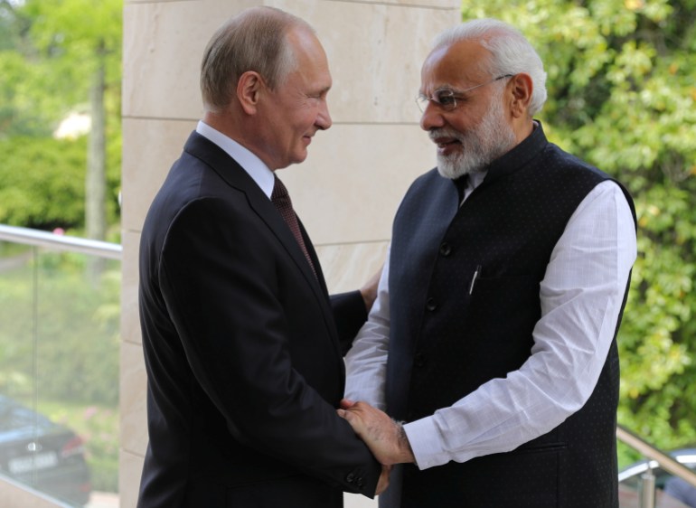 Russian President Vladimir Putin welcomes Indian Prime Minister Narendra Modi during their meeting in the Black Sea resort of Sochi