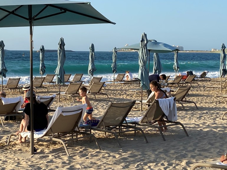 People relaxing on the beach in Dubai