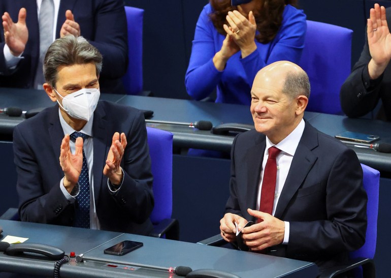 German Chancellor Olaf Scholz receives applause during a session of the German lower house of parliament.