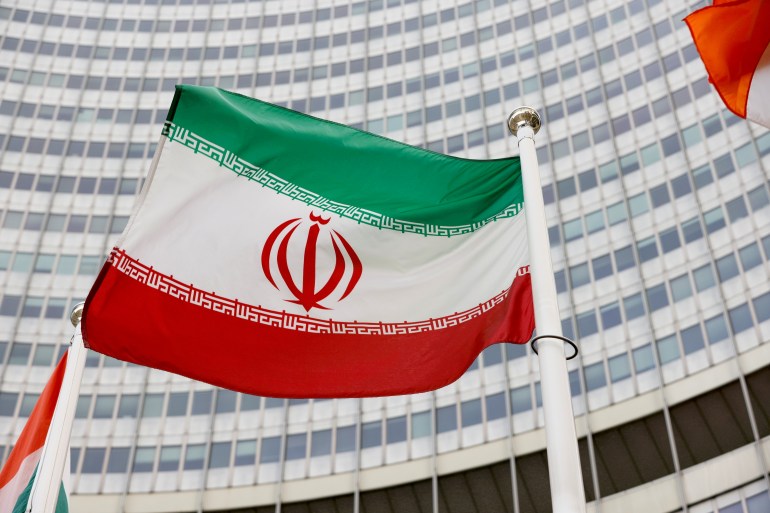 The Iranian flag waves in front of the International Atomic Energy Agency