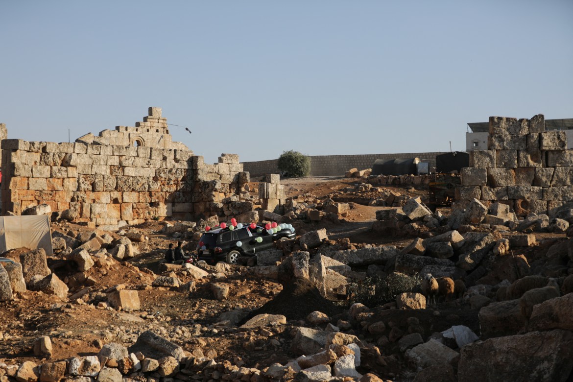 A car decorated for a wedding drives through ruins at the UNESCO World Heritage Site of Babisqa,Syria