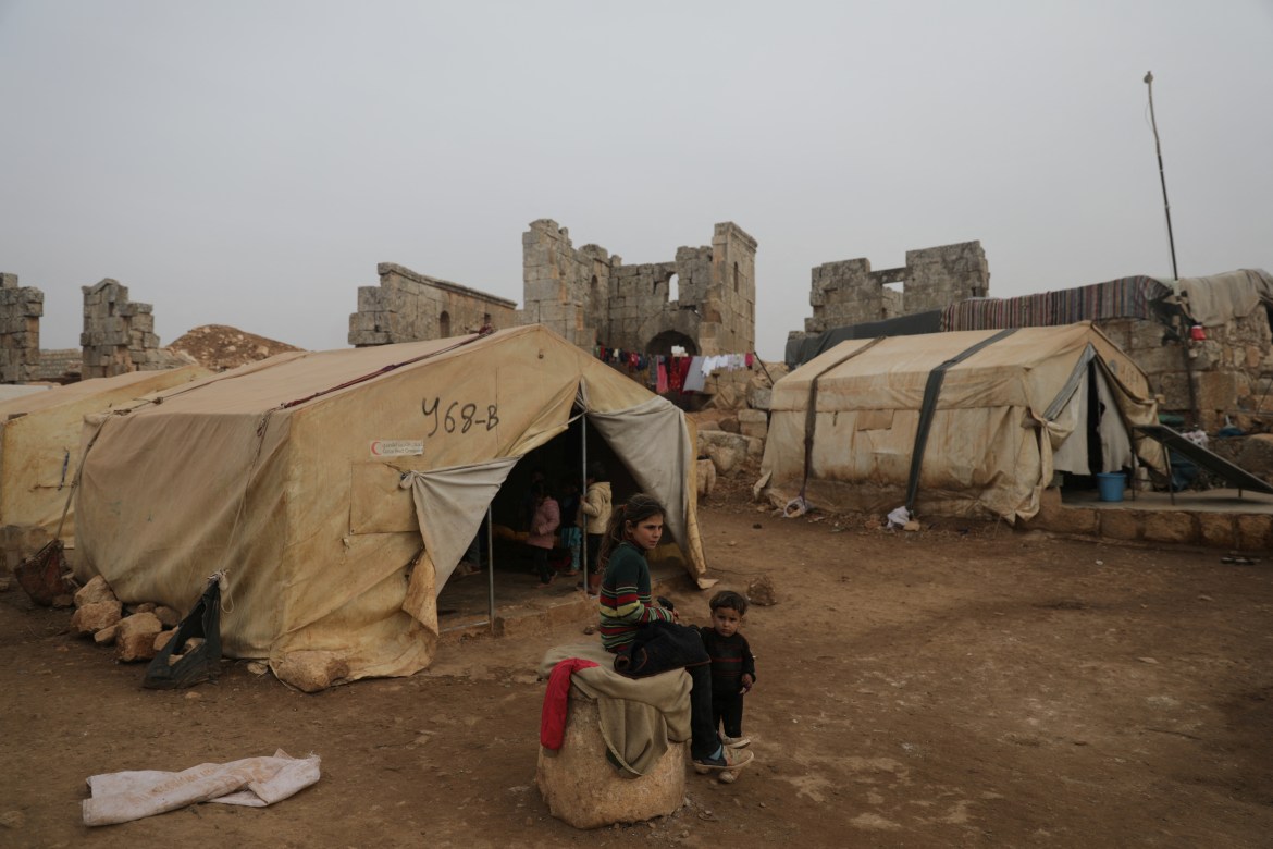 Abeer abo Almajed, 10, sits in front of her family's tent in Babisqa, Syria