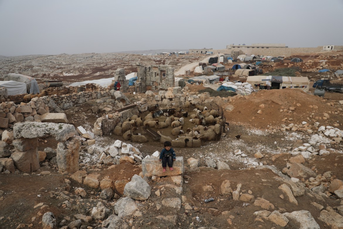 Fatima Mahmoud Abu Khalifa, 4, sits on an ancient stone, at the UNESCO World Heritage Site of Babisqa, Syria