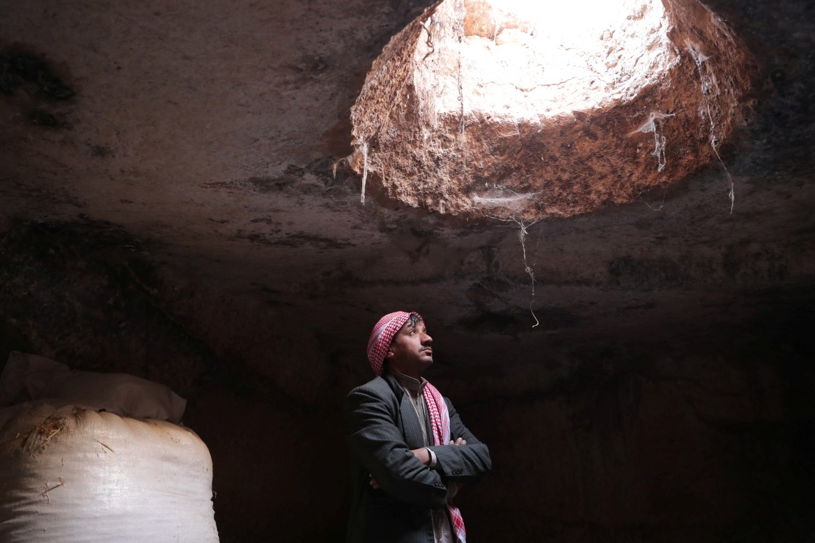 Mahmoud Abu Khalifa stands in an ancient cave at the UNESCO World Heritage Site of Babisqa, Syria
