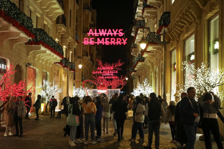 A sign reading "Always be merry" is seen among Christmas decorations in downtown Beirut