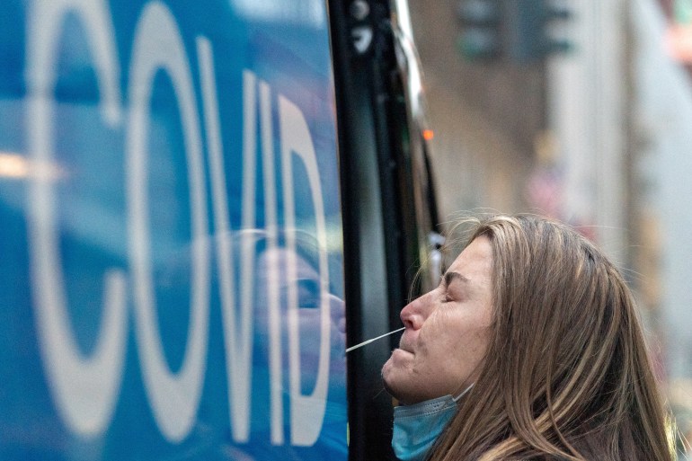 A woman takes a COVID-19 test at a pop-up testing site in New York City