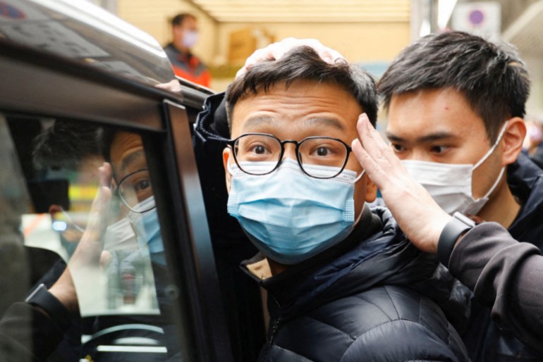 Stand News editor Patrick Lam escorted by police in Hong Kong