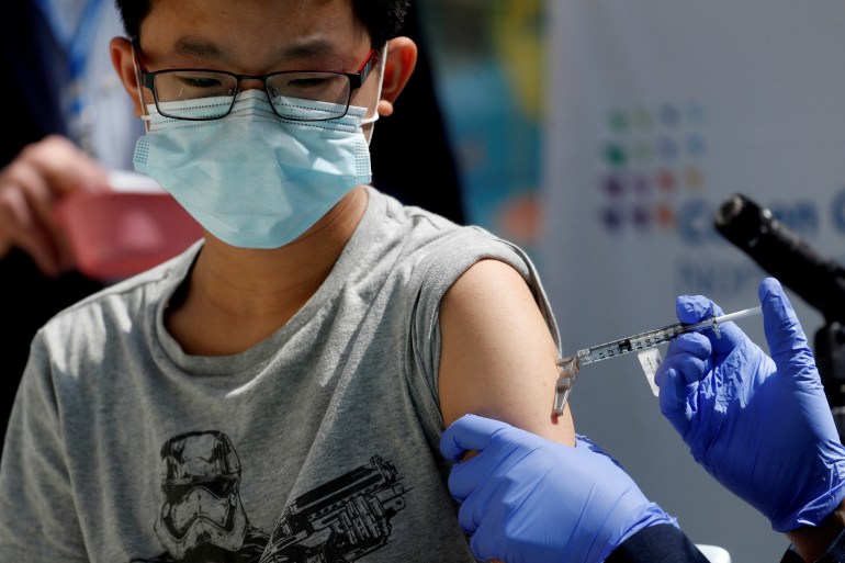 a 13-year old boy receives a Pfizer COVID vaccine