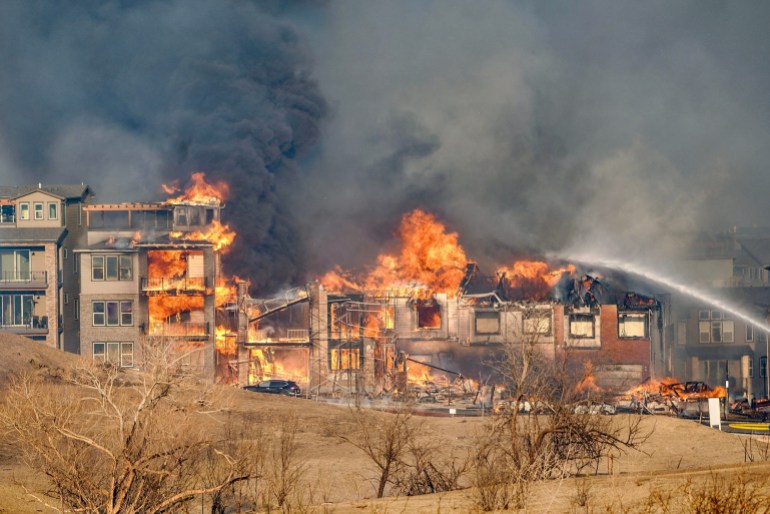 Structures burn as a wildfire forced evacuation in Superior suburb of Boulder, Colorado