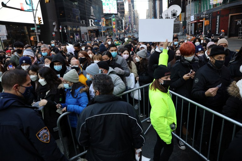 People gather at the security entrance outside Times Square ahead of New Year's Eve celebrations in New York, USA