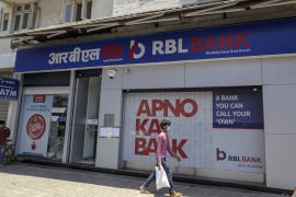 A man walks past a RBL Bank branch in Mumbai, India