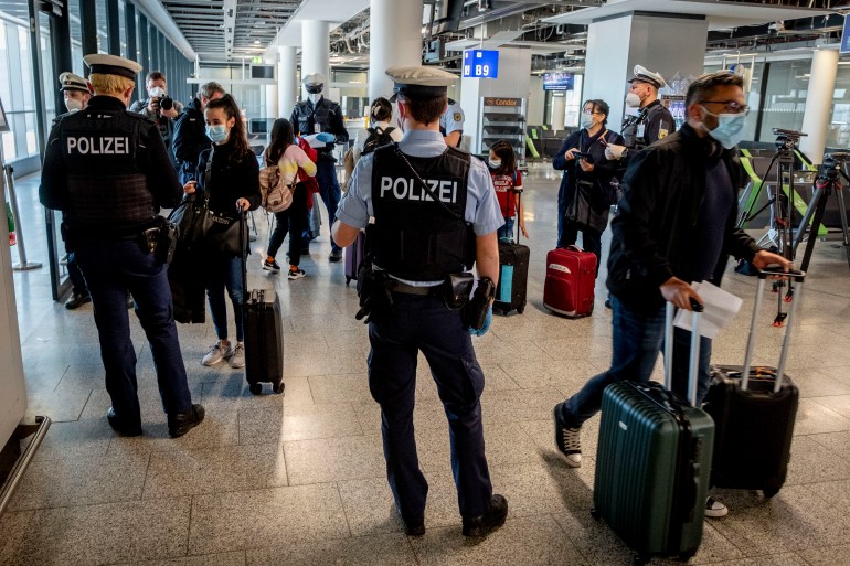 German federal police officers check passengers arriving from Palma de Mallorca
