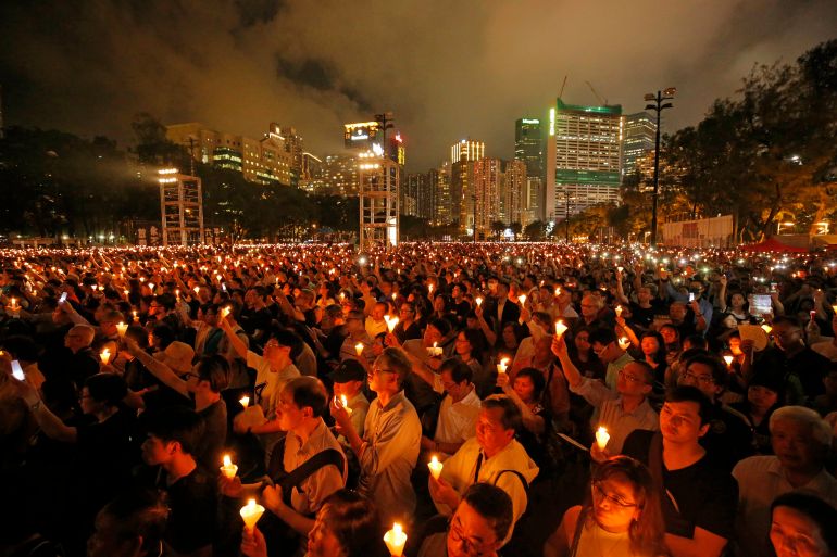 FILE - In this June 4, 2019, file photo, thousands of people attend a candlelight vigil for victims of the Chinese government's brutal military crackdown three decades ago on protesters in Beijing's Tiananmen Square at Victoria Park in Hong Kong. Nine Hong Kong activists and ex-lawmakers were handed jail sentences of up to 10 months Wednesday, Sept. 15, 2021, over their roles in last year's banned Tiananmen candlelight vigil, the latest blow in an ongoing crackdown on dissent in Hong Kong. (AP Photo/Kin Cheung, File)